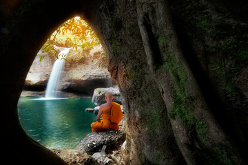 Buddha monk practice meditation at waterfall