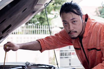 Fototapeta na wymiar A mechanic is fixing car system in automobile service center