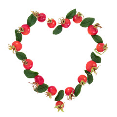 Abstract heart shaped rosehip wreath with red berry fruit & leaves. Very high in vitamin c and antioxidants on white background with copy space. Flat lay.
