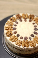 Vegan cake with walnuts, cashew nuts and raisins. Selective focus.