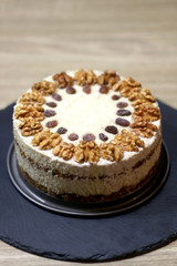 Vegan cake with walnuts, cashew nuts and raisins. Selective focus.