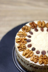 Vegan cake with walnuts, cashew nuts and raisins. Selective focus.