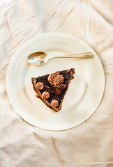 Sliced tasty chocolate cake on white background. Copy space. Top view..Kinfolk and sweet food atmosphere concept