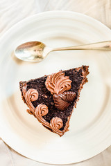 Sliced tasty chocolate cake on white background. Copy space. Top view..Kinfolk and sweet food atmosphere concept