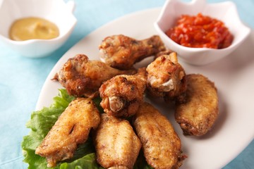  fresh fried chicken legs with sauce and herbs