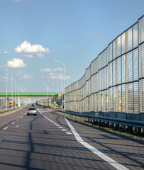 high transparent barrier on the highway for protection against noise