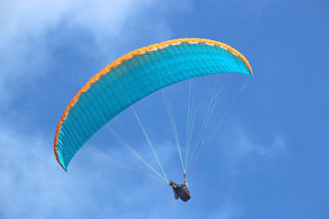 Paraglider flying wing in a blue sky	