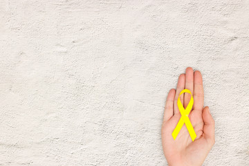 Yellow ribbon for world childhood cancer day - Support for the fight against cancer