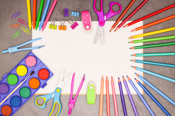 Back to school - White drawing block and school and art supplies on grey background 
