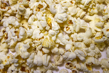 Popcorn on a white table. The texture of popcorn.