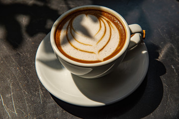 Top view beautiful Latte art in white cup of coffee 