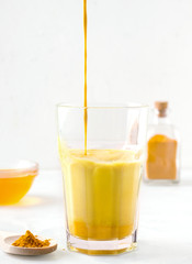 milk tea with turmeric and honey on a white background