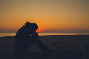 Beautiful woman sitting alone Lonely, disappointed and sad Heartbreak of life issues Style...