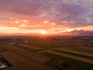 DRONE: Flying over idyllic sunlit pastures reveals a village in the distance.
