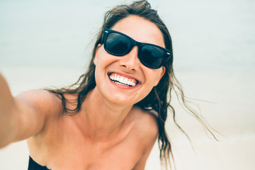 Close up shot of happy smiling female tourist. Poses for selfie