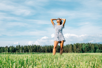 Candid girl in the middle of a field in summer