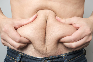 Man checking his weight isolated