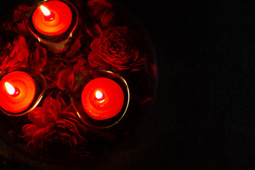red candles in a candlestick on a black background, top view