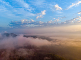 Fototapeta premium Aerial view forest in morning fog mist, breathing mountains, Sunshine on The Morning Mist