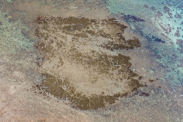 Isolated beautiful tropical island with white sand beach and blue clear water and granite stones. Top view, speedboats above coral reef. Similan Islands, Thailand.