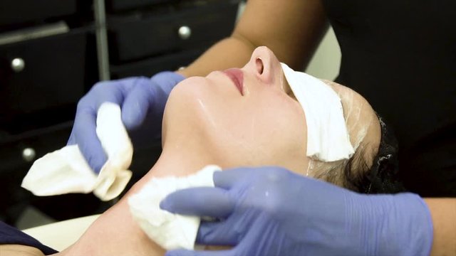 close up view of a young polish European woman receiving a relaxing facial treatment at a local spa from a well trained dermatologist. The client beauty therapy is great for skin care and health