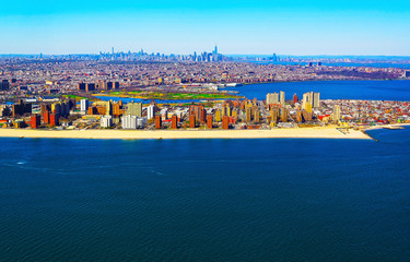 Helicopter view on Coney Island Beach and Boardwalk. Skyline with Skyscrapers in Manhattan Area, New York City, America USA. American architecture building. NYC. Cityscape. Hudson, East River NY