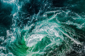 Abstract background. Waves of water of the river and the sea meet each other during high tide and...