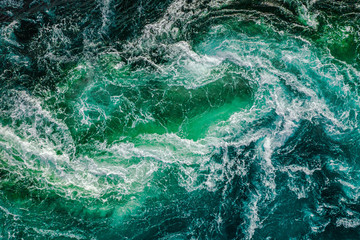 Abstract background. Waves of water of the river and the sea meet each other during high tide and...