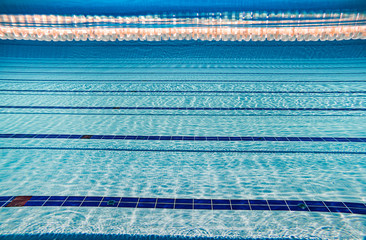 Olympic Swimming pool under water background. - obrazy, fototapety, plakaty