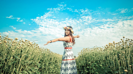 Happiness freedom girl in flower field,Woman with flower crown in sweet dress.