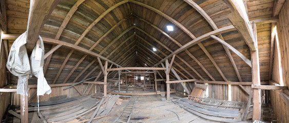 Old and dusty creepy wooden attic with roof framework structure of the old house Awesome horror attic