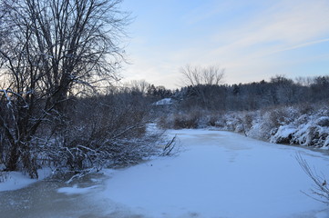 Sunrise over the frozen river during winter