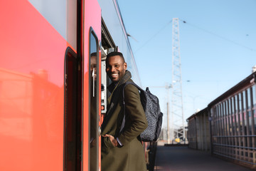 Portrait of happy man entering a train