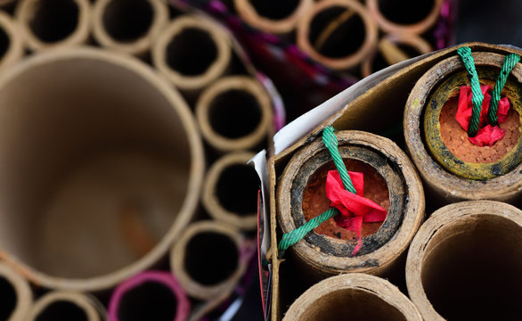 Close-up and top view of partially burned-down fireworks that are left after the Sylvester night or party, with duds in a cardboard box