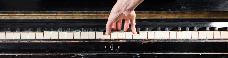 Female pianist hands playing on piano keyboard