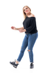 Feminine middle age modern woman dancing carefree in casual clothes wearing jeans and sneakers....