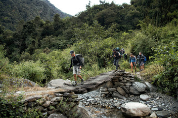 Trekking group crossing river at Myagdi Khola Gorge, Dhaulagiri Circuit Trek, Himalaya, Nepal