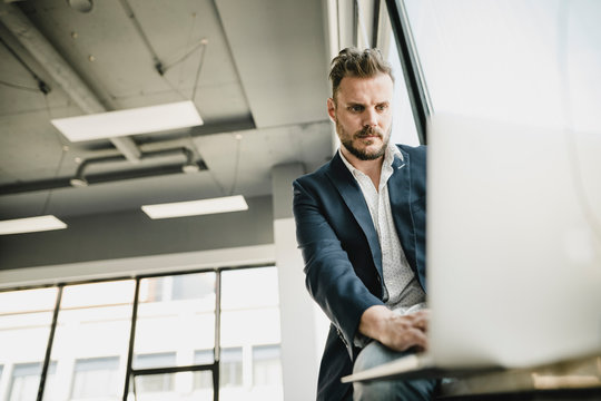 Businessman using laptop in coworking space