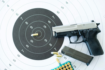 Guns with ammunition on paper target shooting   practice © tonefotografia