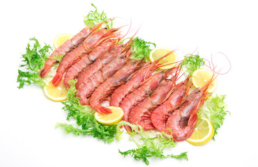 Raw fresh Prawns with salad and lemon slices on white background