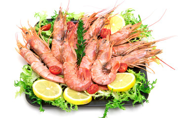 Raw fresh Prawns on black dish on white background