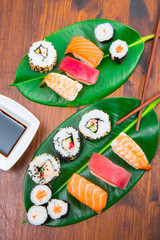 mixed sushi on green leaf