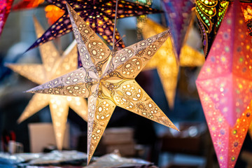 Christmas Paper Stars on sale at market stall at Bath Christmas Market, Bath, Somerset, UK on 13...