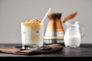 Iced latte with frozen coffee cubes and sweet cream