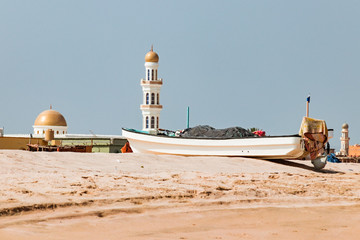Beach with Mosque in background, Oman