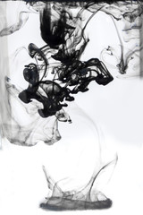 Black Smoke or black ink texture spread with white background