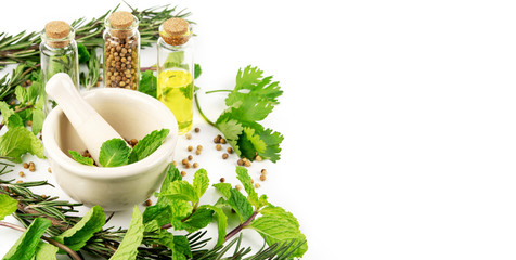 mortar with herbs on white background © boommaval