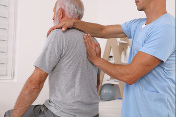 Chiropractic / Osteopathy treatment, Back pain relief. Physiotherapy for senior male patient
