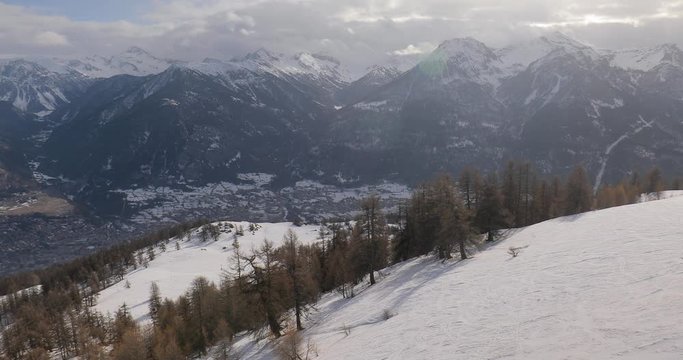 Snowy alpine landscape with falling snow from an ascending ski lift