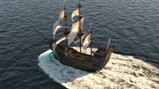 A medieval ship sailing on a vast blue sea. Concept of sea adventures in the Middle ages.